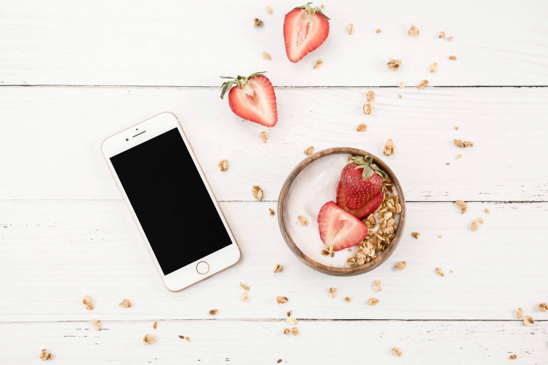 iphone and bowl with strawberries